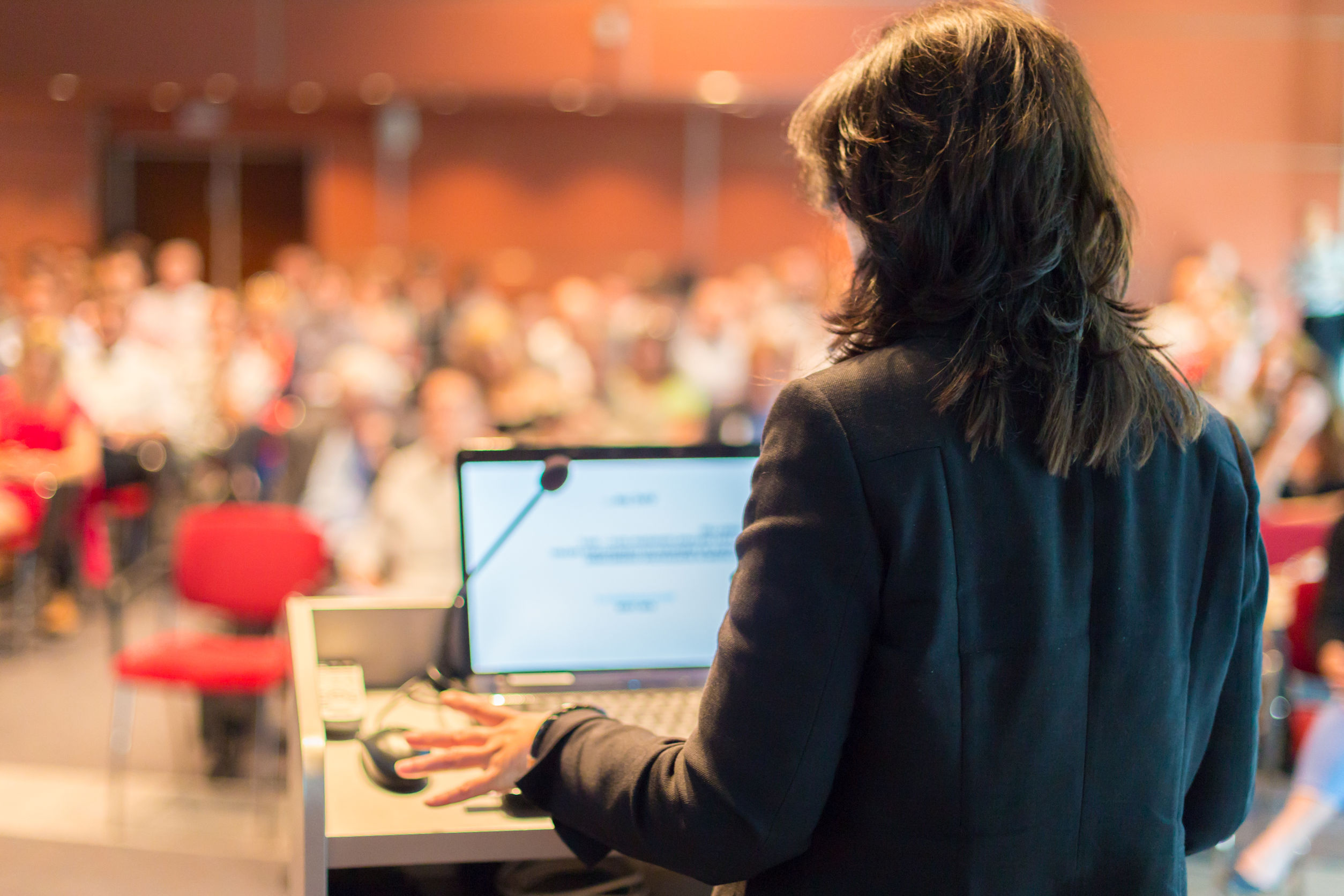 Business woman lecturing at Conference.