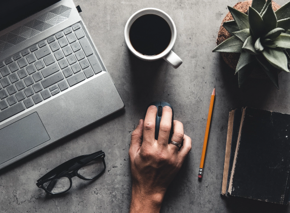 office-desk-flat-lay-view-with-laptop-mouse-tree-paper-clip-coffee-cup-notebook-pencil-black-glasses-white-background